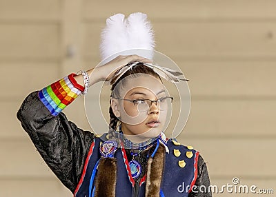 A medium shot of an indigenous woman talent showcase wearing a black traditional dress. Editorial Stock Photo