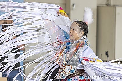 A medium shot of a indigenous woman talent showcase wearing a white traditional dress. Editorial Stock Photo