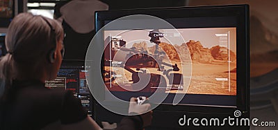 Woman controlling Mars rover with remote controller Stock Photo