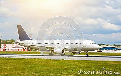 Big silver passenger jet plane on runway at airport a sunny day Stock Photo