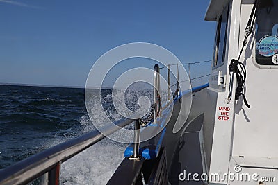 Boat motoring through the sea Stock Photo