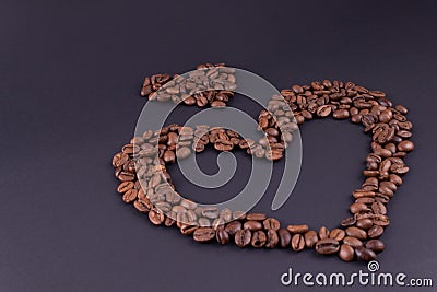 Big and small hearts from coffee in the lower right corner on a dark background Stock Photo