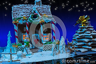Big snow-covered homemade gingerbread house with lights inside, Stock Photo