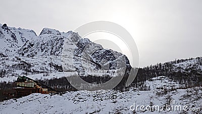 Big snow covered mountain near Holdoya on Hinnoya in winter in Norway Stock Photo