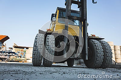 big spiked wheels of yellow tractor durable rubber tires Stock Photo