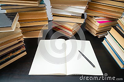 Big stack of books on the table. Studying before the exam. Pile of vintage books. Concept of education and studying Stock Photo