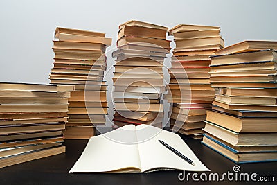 Big stack of books on the table. Studying before the exam. Pile of vintage books. Concept of education and studying Stock Photo