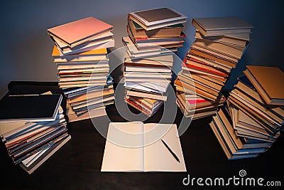 Big stack of books on the table. Studying before the exam. Pile of vintage books. Concept of education and studying Stock Photo