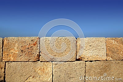 Big stone bricks masonry wall on port blue sky Stock Photo
