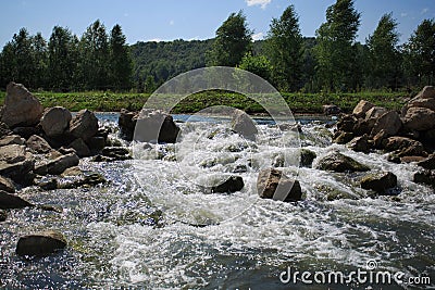Big stones in litlle waterfall at sunny day Stock Photo