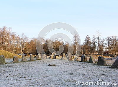 The big stones standing in the snow field in winter Stock Photo