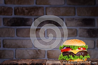 Big tasty classic hamburger on rustic wooden table Stock Photo