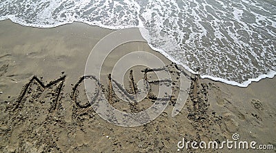 BIG text MONEY on the sand of the sea Stock Photo