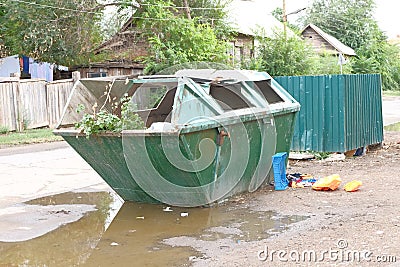 Big trash can in ghetto in the street Stock Photo