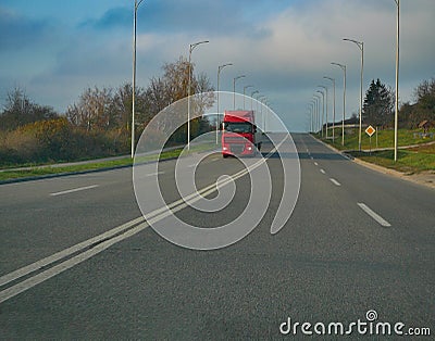 Big truck lorry moving at countryside two lane road Stock Photo
