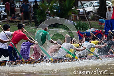 SIEM REAP, CAMBODIA - NOVEMBER, 2016: Medium action shot of team of boat racers paddling hard Editorial Stock Photo