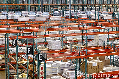 Big warehouse with red racks full of boxes Stock Photo