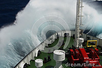 Big wave rolling over the snout of the ship Stock Photo