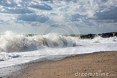 Big waves roll up on the beach Stock Photo