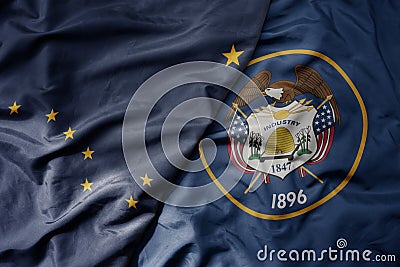 big waving colorful national flag of utah state and flag of alaska state Stock Photo