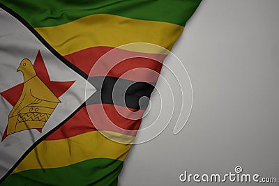 big waving national colorful flag of zimbabwe on the gray background Stock Photo