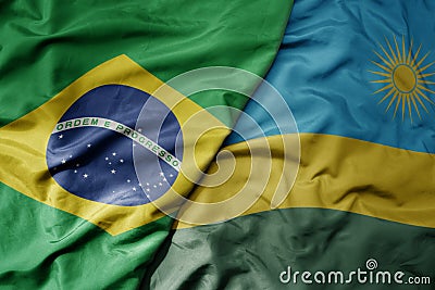 big waving realistic national colorful flag of brazil and national flag of rwanda Stock Photo