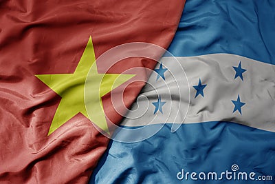big waving realistic national colorful flag of vietnam and national flag of honduras Stock Photo