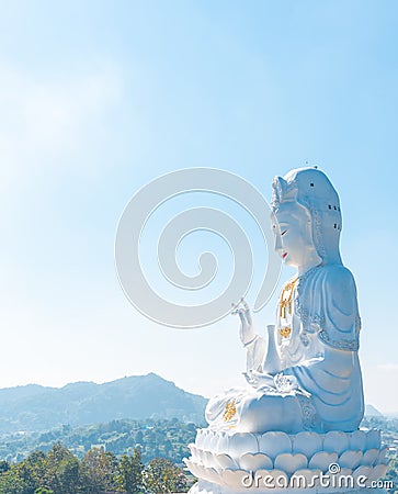 Big white bodhisattva guanyin statue with blue sky background at Wat Huai Pla Kung temple, Chiang rai,Thailand.Asian Landscape Stock Photo