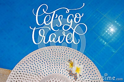 Big white hat on the edge of the pool and text Lets go travel. Calligraphy lettering hand draw Stock Photo