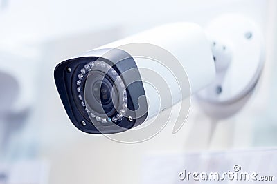 Big white professional surveillance camera. CCTV mounted on ceiling. LED IR lights around lens. Security system concept. Copyspace Stock Photo