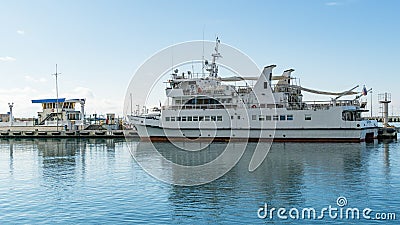 Big white three-deck motor ship `Dagomys` in Sochi Commercial Sea Port. Editorial Stock Photo