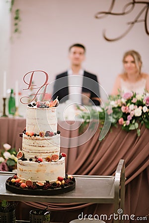 Big white wedding cake with fruit is on the table Editorial Stock Photo