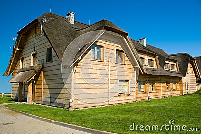 Big wooden house with straw roof Stock Photo