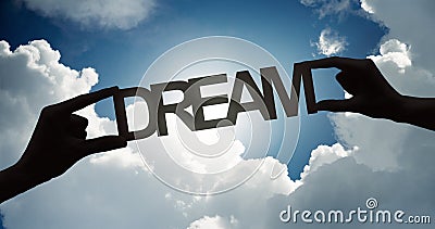 Big wooden text Dream in hands in front of white clouds Stock Photo