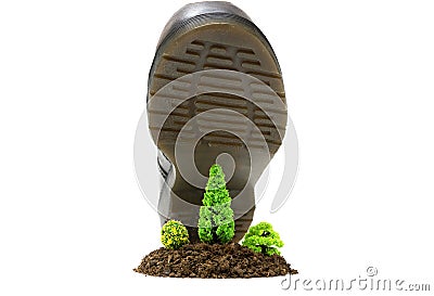 Big work boot stepping on a small miniature forest made of soil and toy plastic trees. Deforestation and illegal logging concept Stock Photo