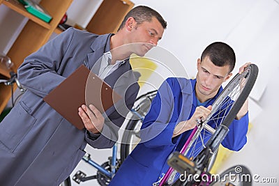 Bike apprentice being marked by teacher Stock Photo