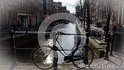 Bike on the bridge in Amsterdam with canal background Stock Photo