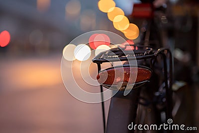 Bike in the city, dusk: Rear picture of a city bike, blurred background Stock Photo