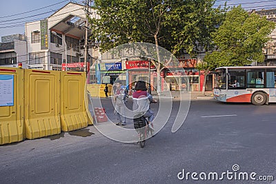 A bike junior high school student. Is passing through a construction road. Editorial Stock Photo