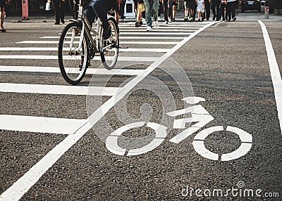 Bike lane street crosswalk with People ride bicycle crossing urban city lifestyle Stock Photo