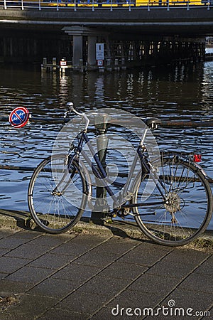 Bike is parked under the sign Â«no bikesÂ» Stock Photo