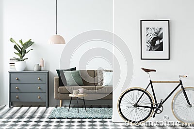 Bike and poster on the wall in a modern living room interior wit Stock Photo