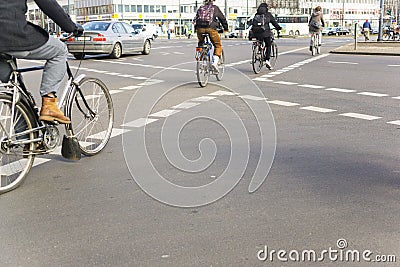 Bike riding commuters from behind in central Berlin Editorial Stock Photo