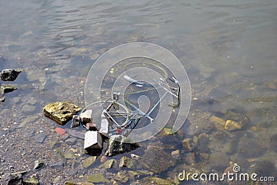 Bike in river - water pollution Stock Photo