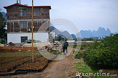 Bike tours and cycling to villages around Yangshuo, Guilin, Guangxi with beautiful karst landscape in China Editorial Stock Photo