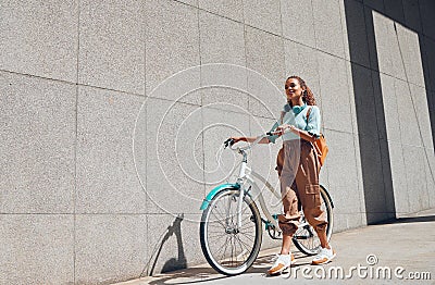 Bike, urban and city woman on a bicycle ride walking to cut carbon footprint for sustainability. Person relax after Stock Photo