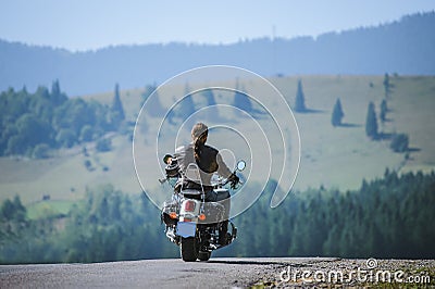 Biker driving his cruiser motorcycle on road Stock Photo