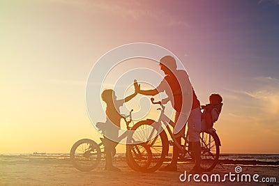 Biker family silhouette, father with two kids on Stock Photo