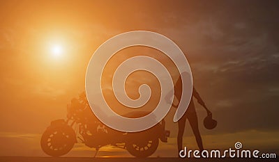 Biker girl and classic motorcycle at sunset Stock Photo