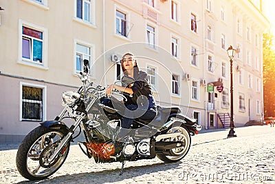 Biker girl in a leather jacket on a motorcycle Stock Photo